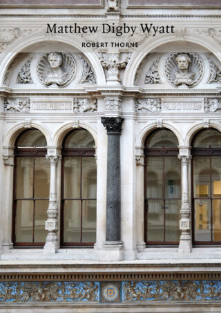 Cover of the book about Matthew Digby Wyatt which shows windows at the Durbar Court in the centre of the Victorian-era Foreign & Commonweath Office in London. The windows are in white stone with elaborate busts of male figures above black frames. The carving around the windows is detailed and ornate.